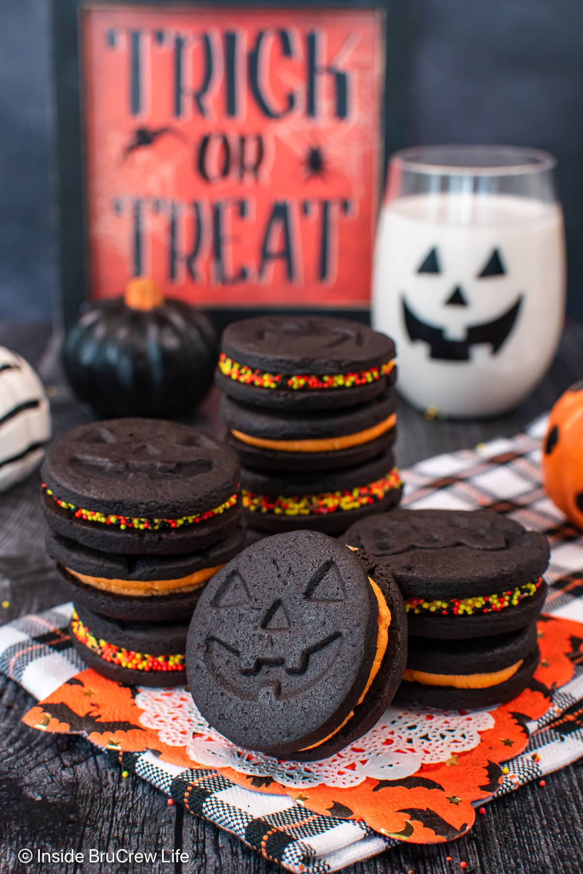 A stack of homemade Oreos with orange filling.