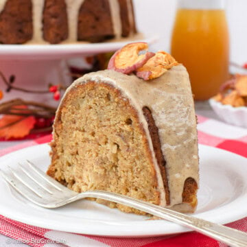 A slice of apple bundt cake on a white plate.