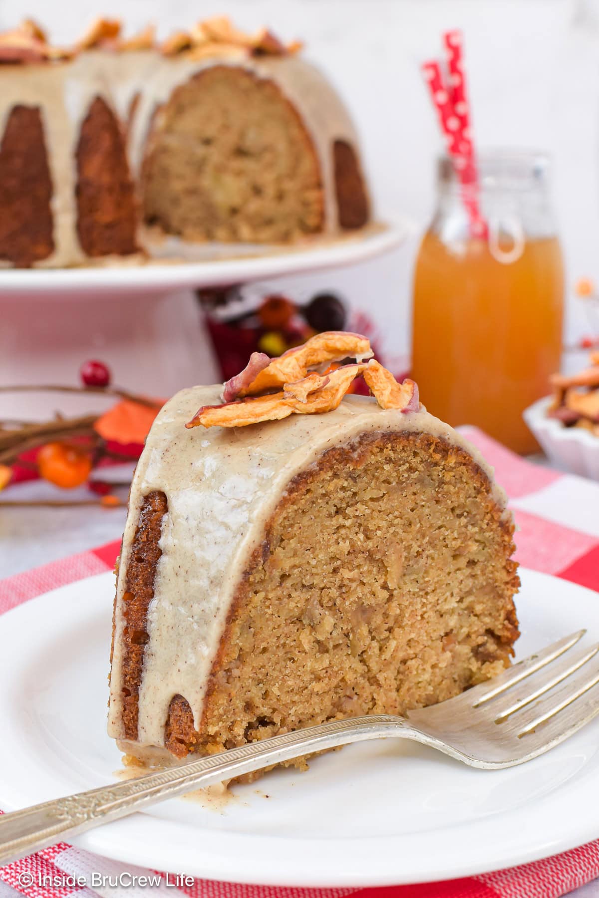 A slice of bundt cake with glaze on a white plate.