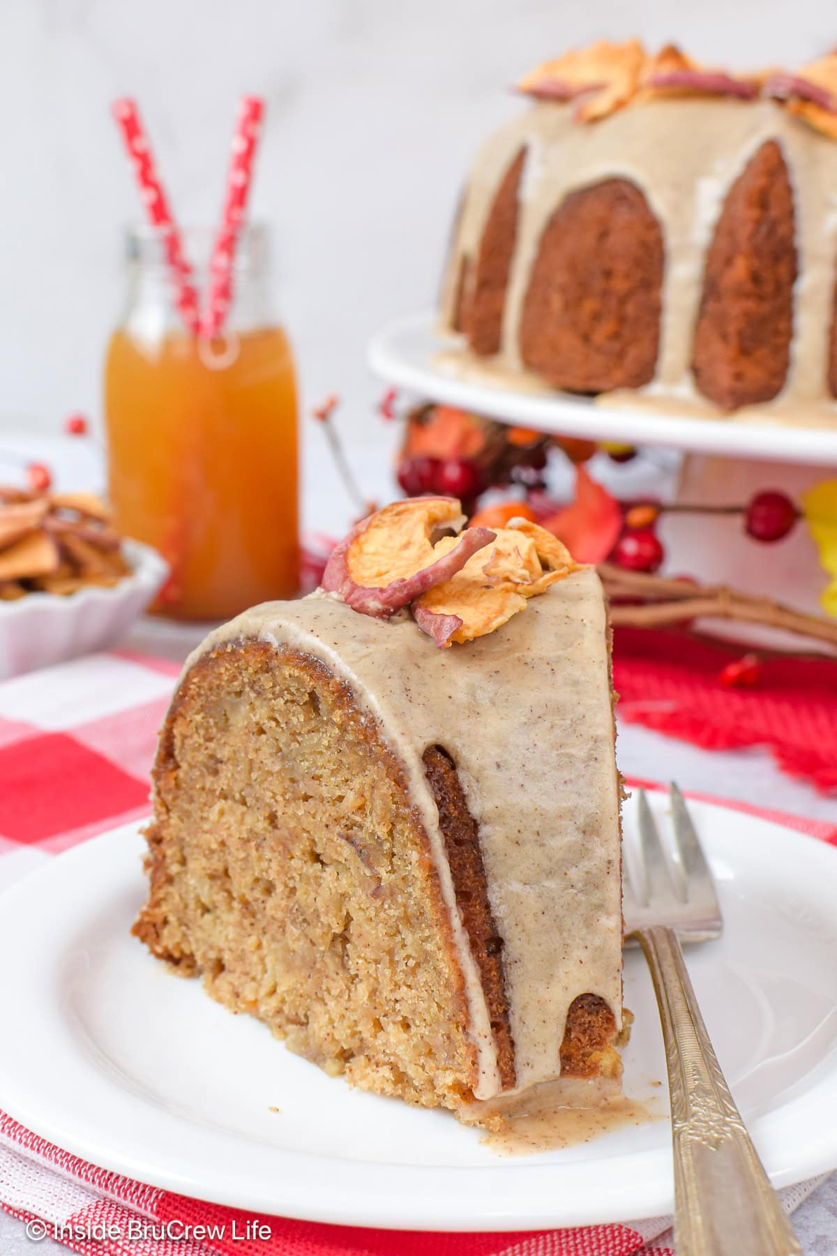 A slice of toffee apple cake on a white plate.