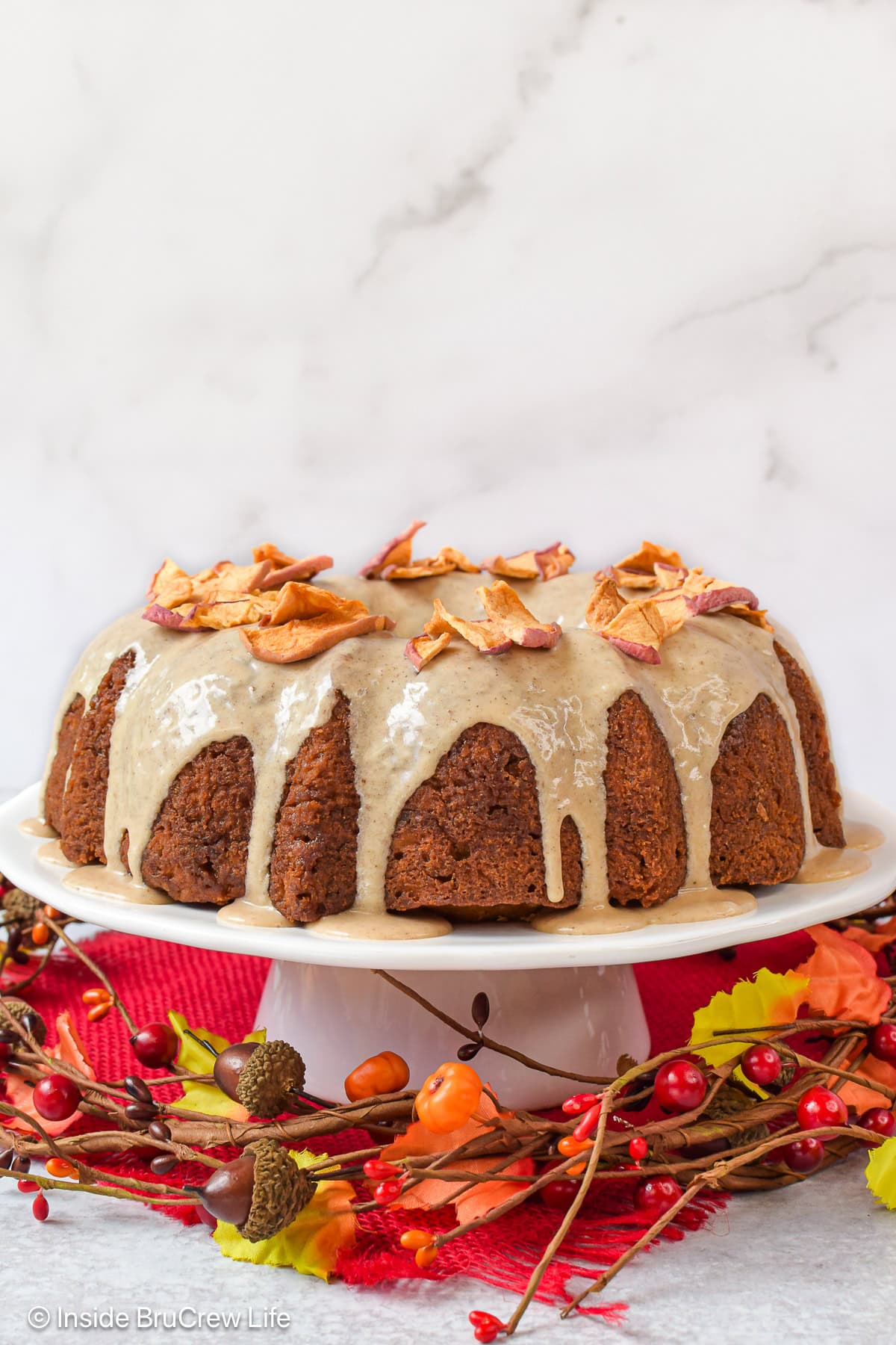 A full toffee apple bundt cake on a white plate.