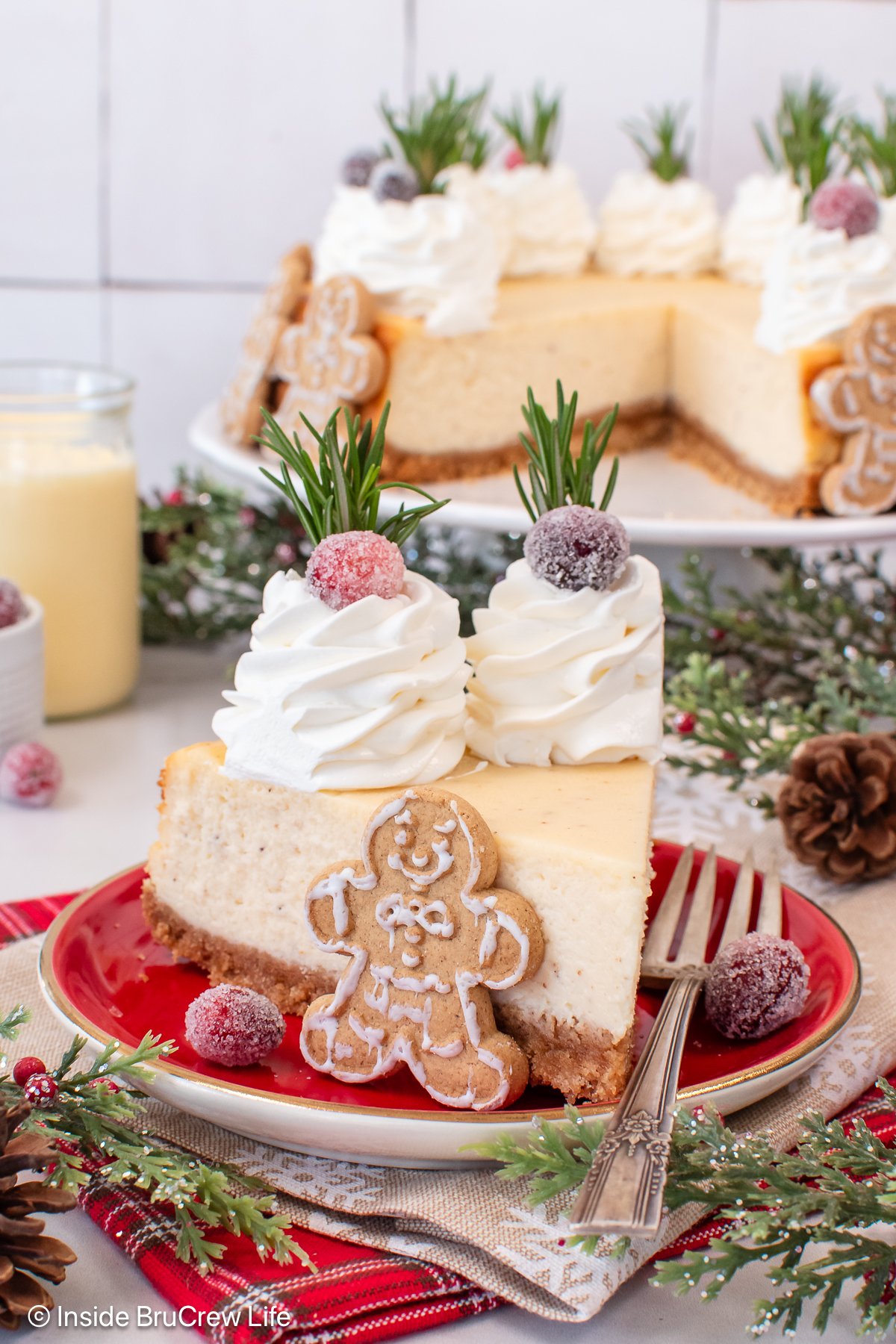 A red plate with a slice of holiday cheesecake on it.