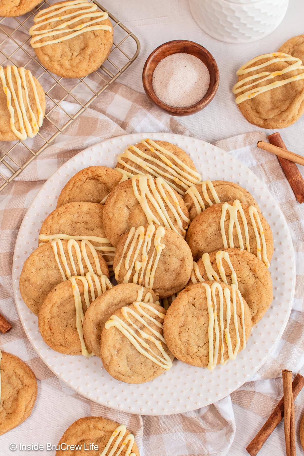 A pile of spiced cookies on a white plate.