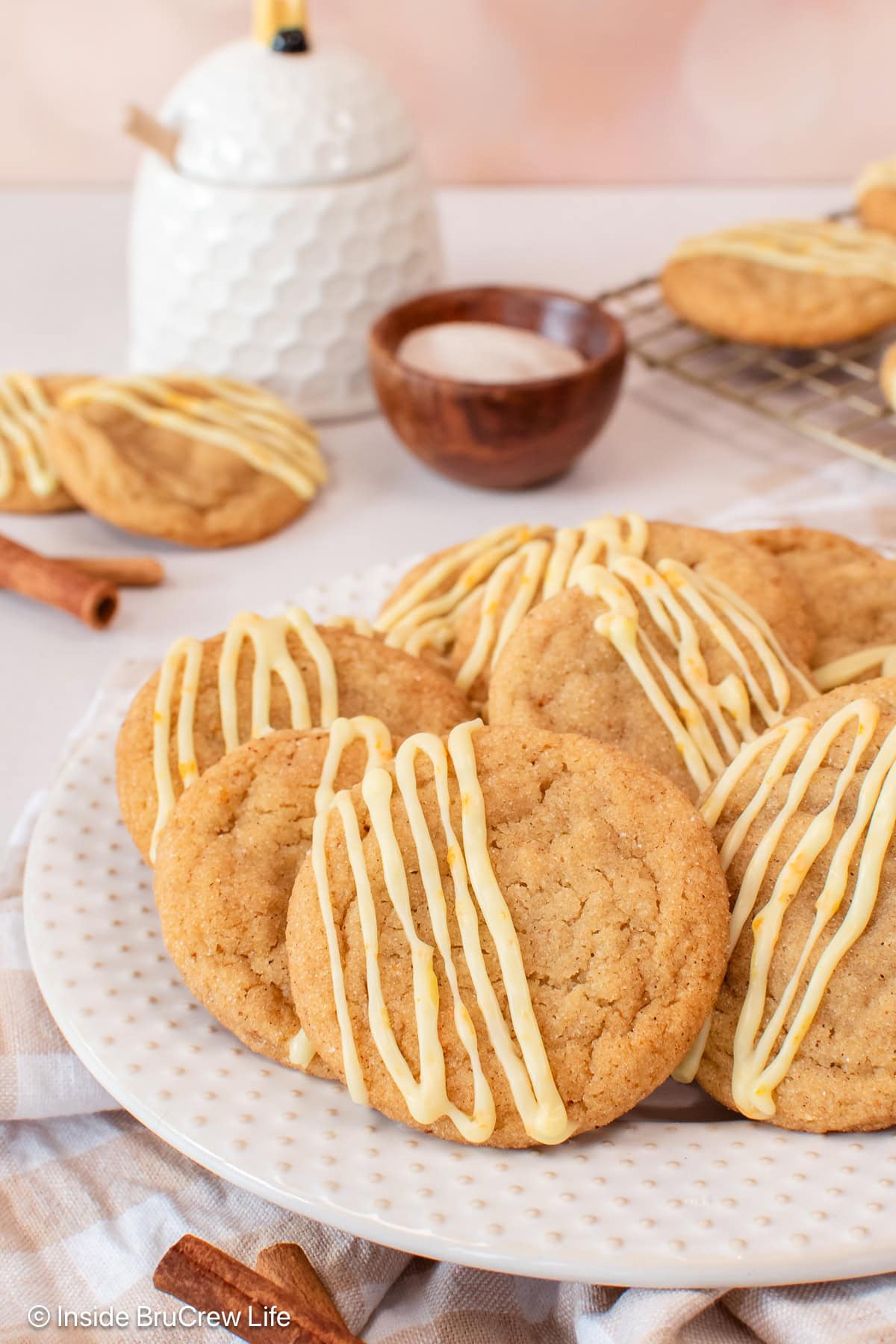 Glazed cardamom cookies on a white plate.