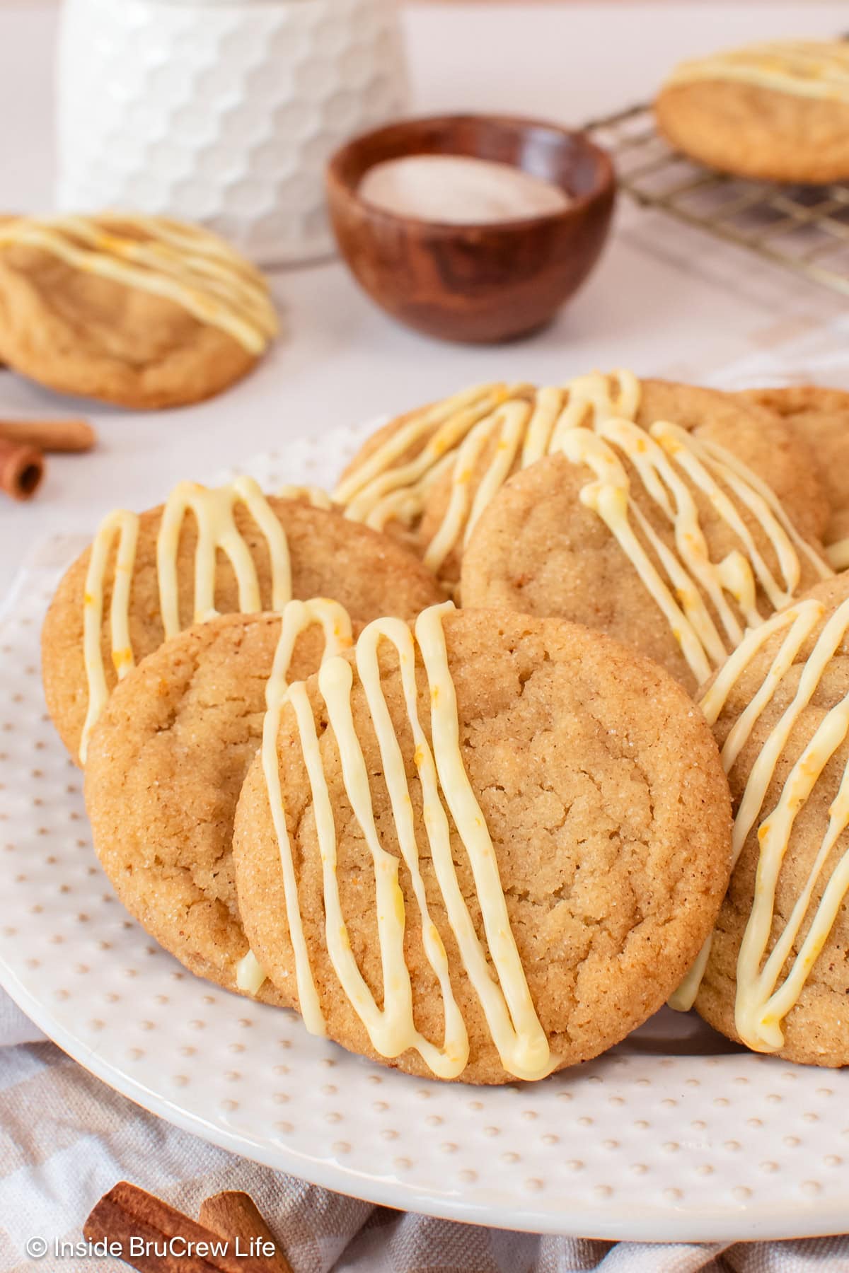 Glazed cardamom cookies on a white plate.