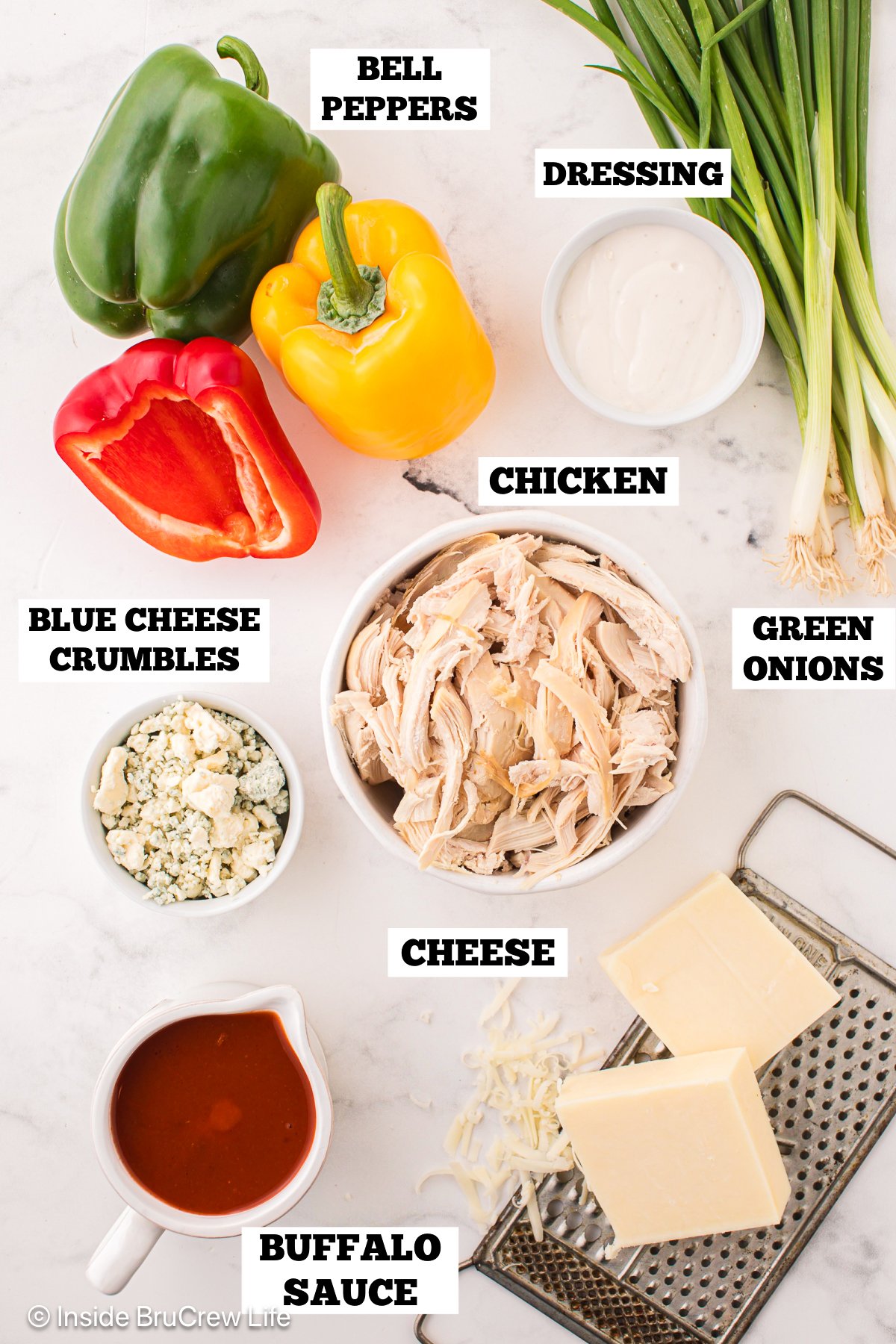 Bowls of ingredients needed to make buffalo chicken peppers.