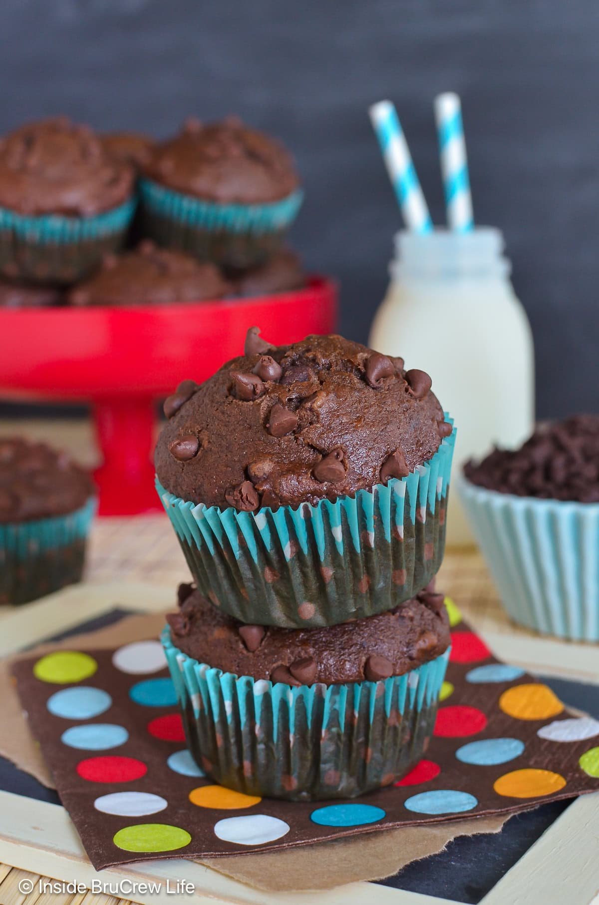 Two stacked muffins with more behind them.