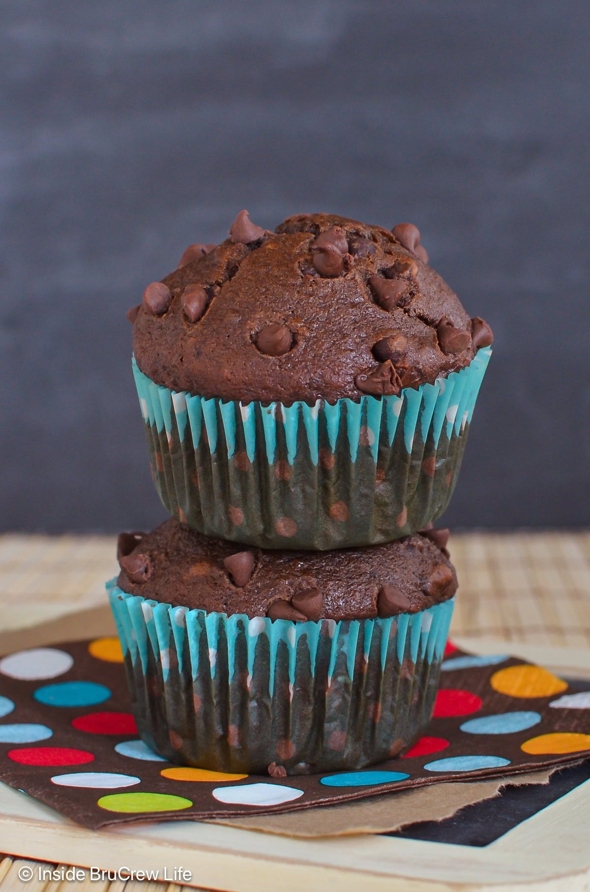 Two chocolate muffins on top of each other.