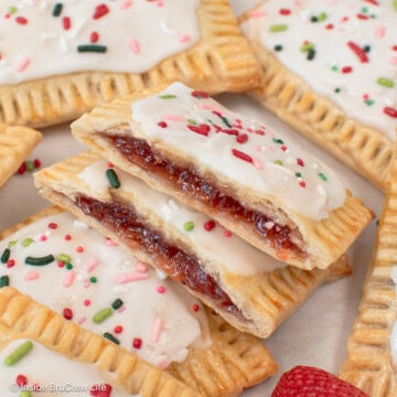 Homemade pop tarts filled with strawberry preserves in a pile.