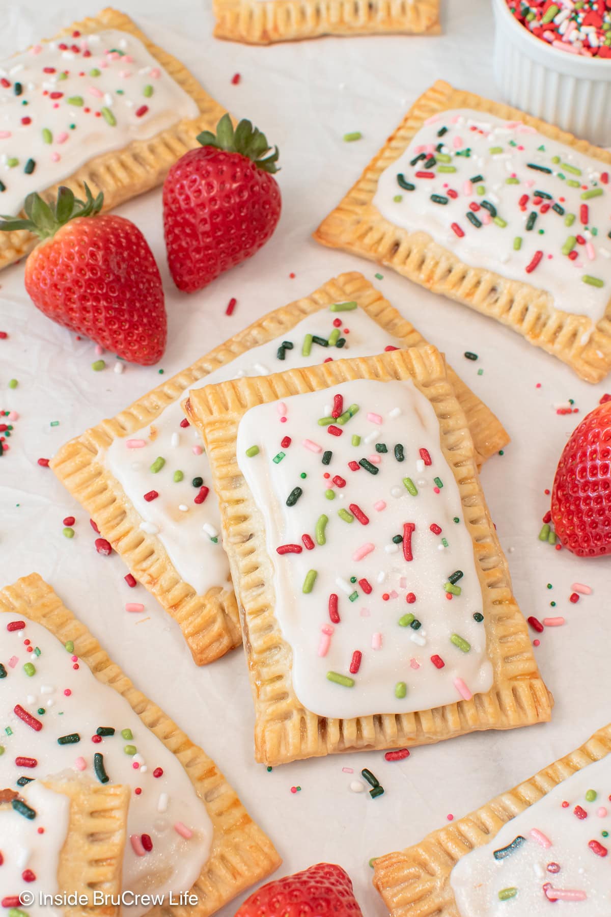 A white board with homemade pop tarts with pie crust laying on it.