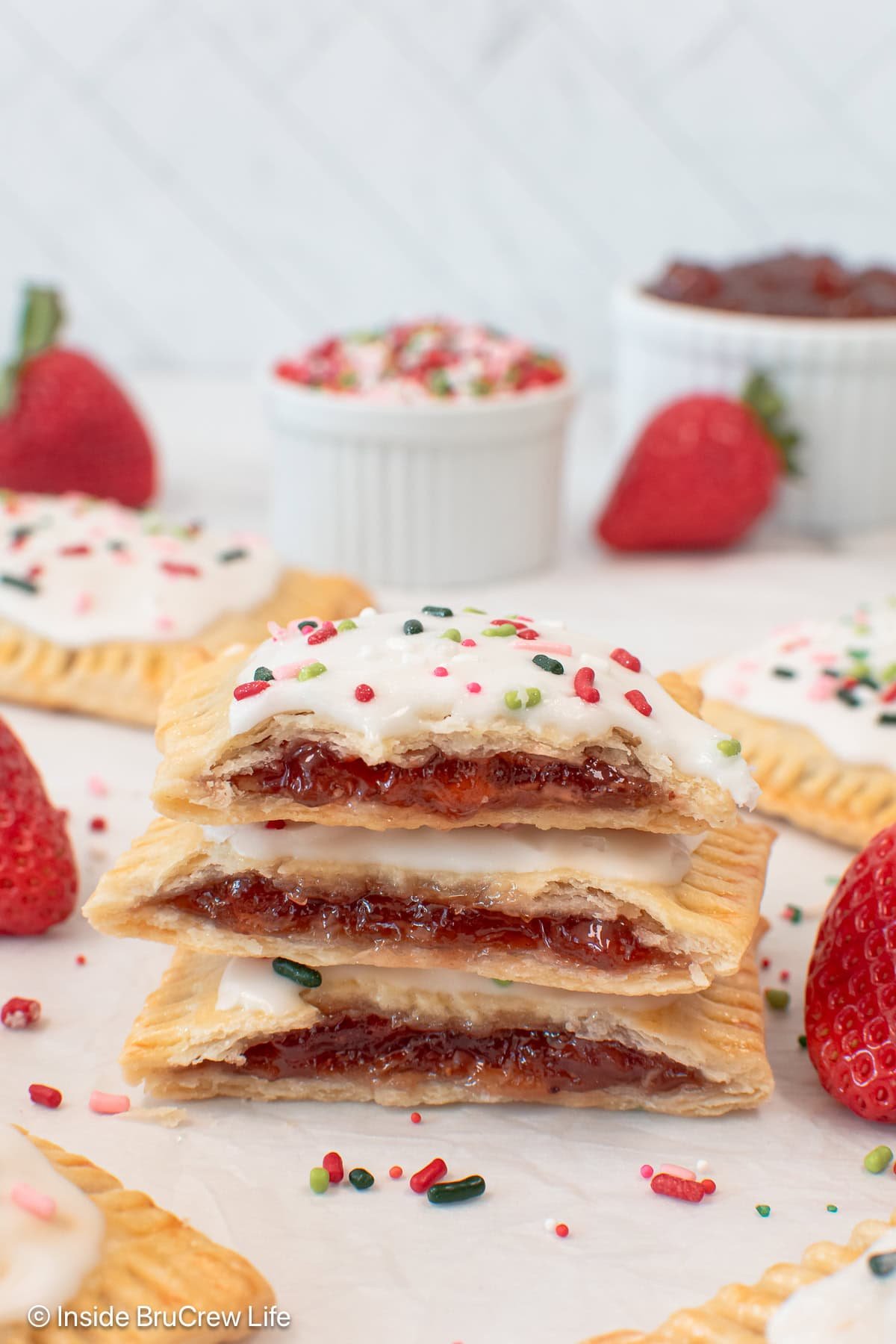 A stack of three homemade strawberry pop tarts cut in half.