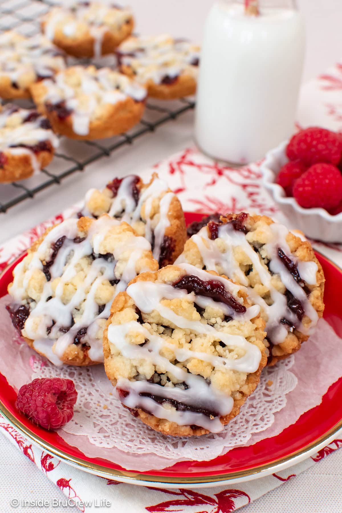 Crumble cookies stacked on a red plate.