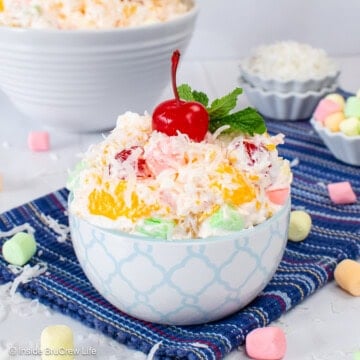 A small bowl of ambrosia salad sitting on a blue towel.