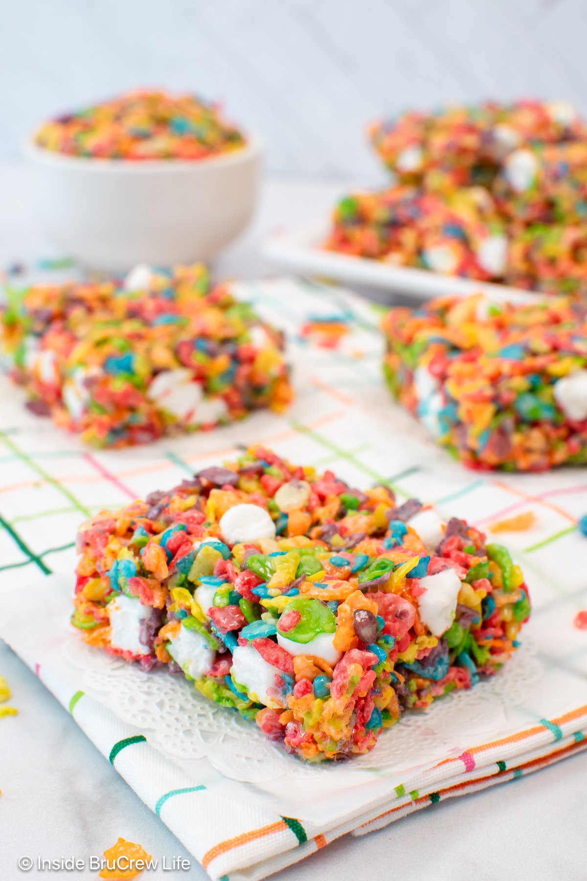 Fruity rice crispy treats on a white towel.