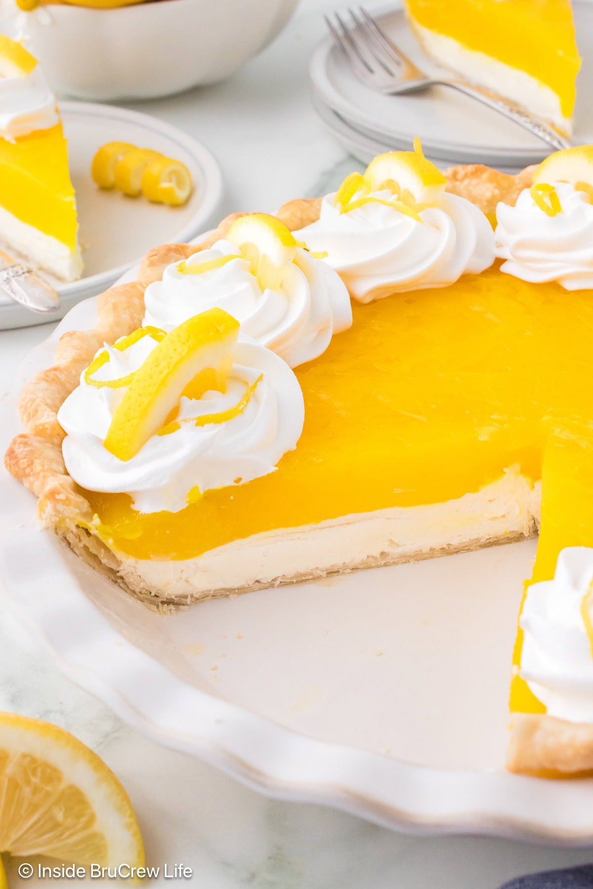 A pie plate with a partial lemon cream cheese pie.
