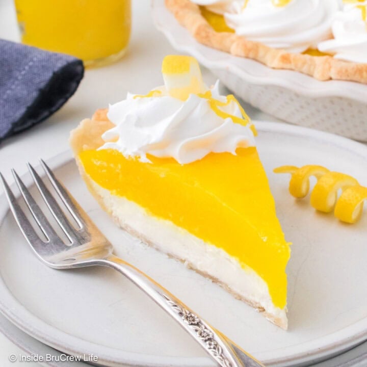 A slice of lemon supreme pie on a white plate.