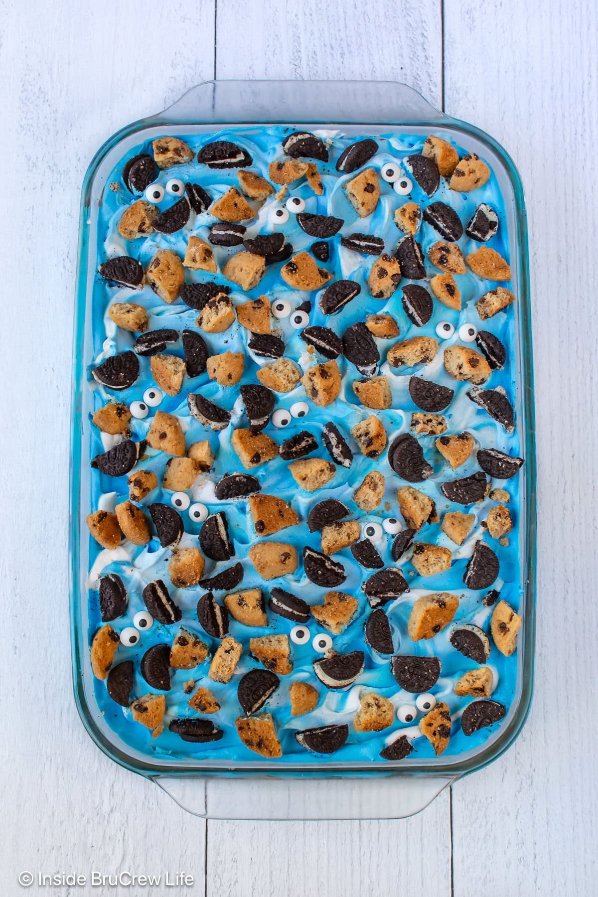 A pan of blue cookie dessert topped with extra cookies.