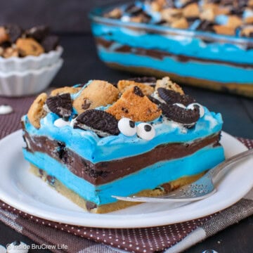 A slice of cookie monster dessert on a white plate.