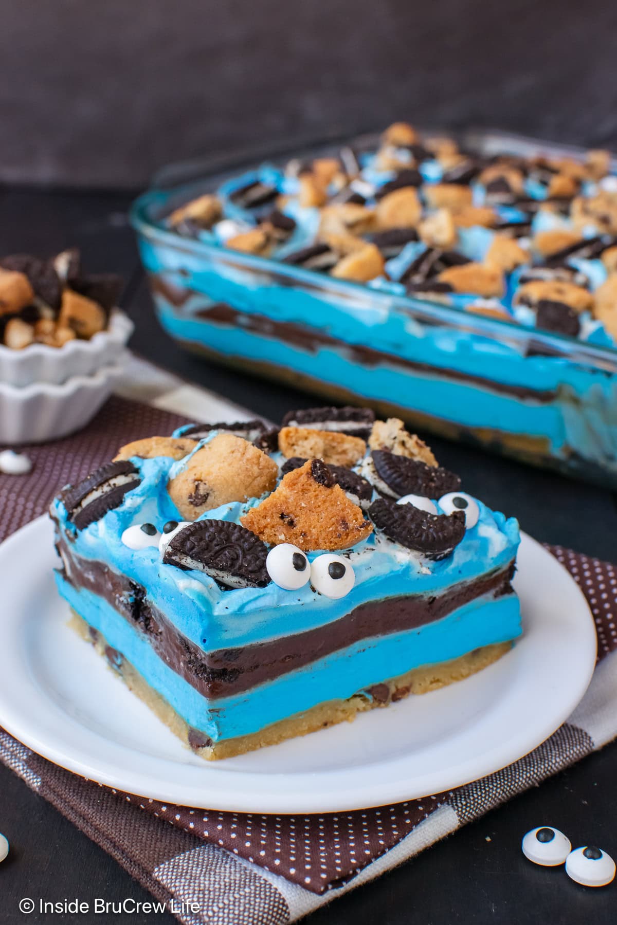 A slice of cookie monster dessert on a white plate.