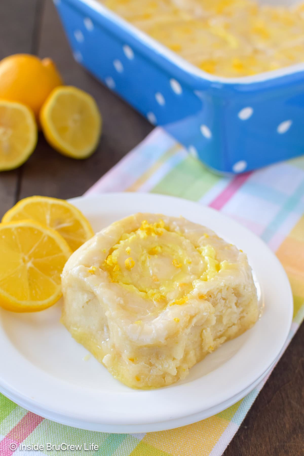 A lemon roll on a white plate.