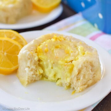 A lemon filled sweet roll on a white plate.
