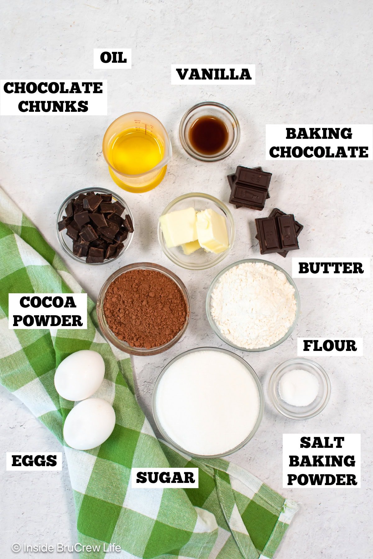 A white board with bowls of ingredients needed to make a copycat recipe for Starbucks brownies.