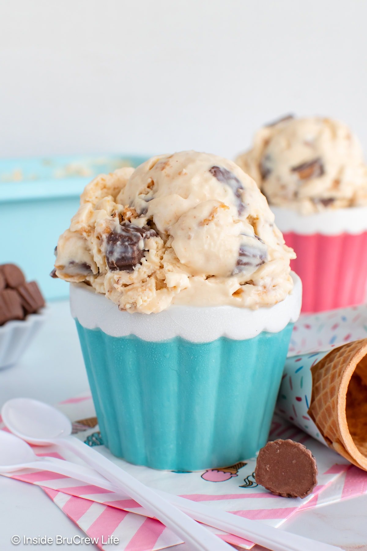 A blue bowl with a large scoop of no churn peanut butter ice cream in it.
