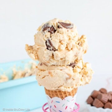 Two scoops of peanut butter ice cream on a sugar cone.