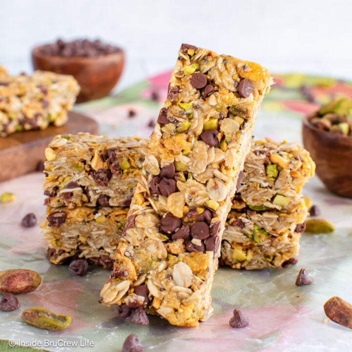 Pistachio granola bars stacked and leaning together on a towel.