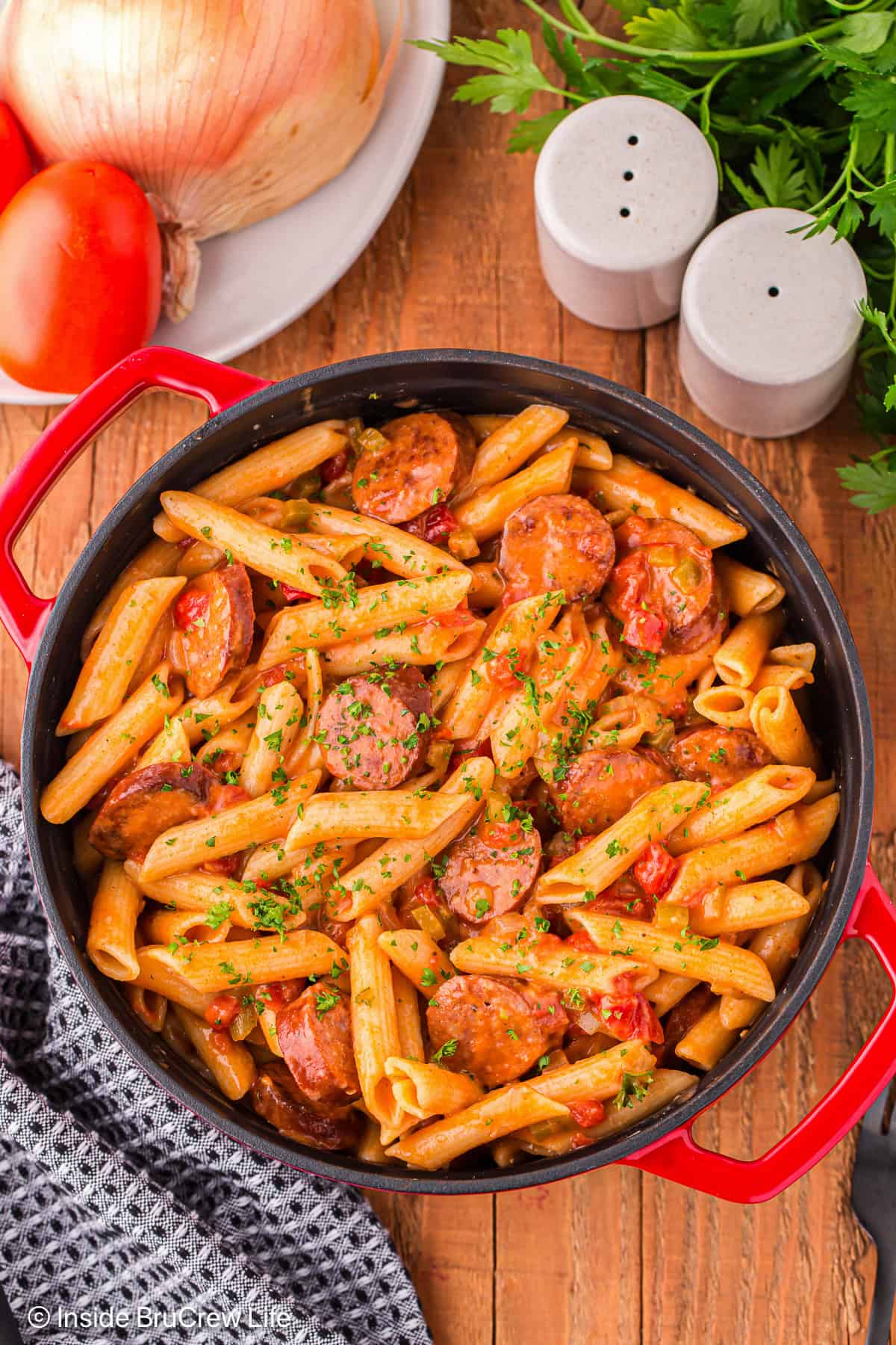 Pastalaya is a fun twist on jambalaya. It's made with pasta, smoky sausage, veggies, and Creole spices, all simmered in a savory sauce. Overhead image of pastalaya in a Dutch oven.