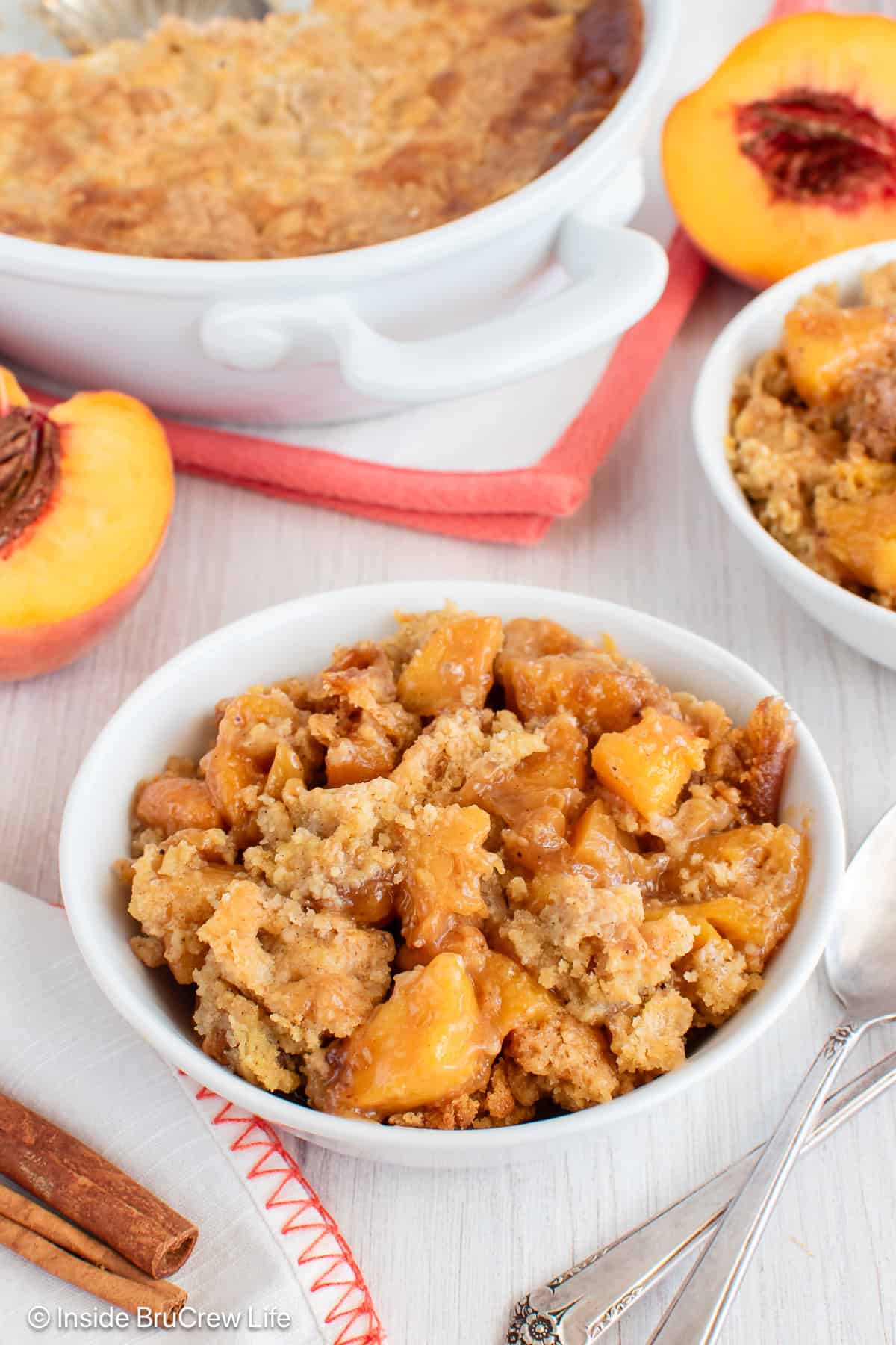 A white bowl filled with peach dump cake.