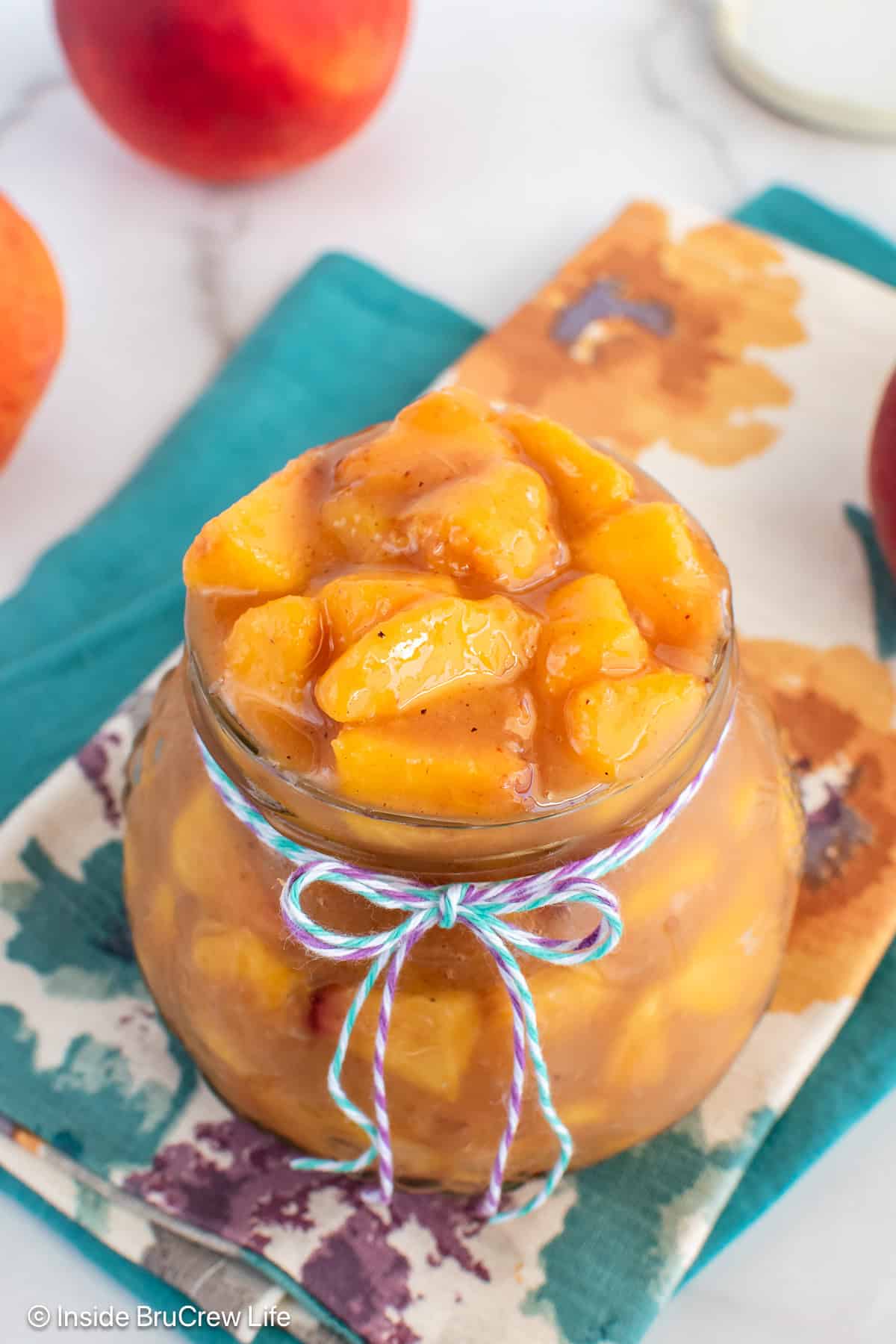 Peach pie filling filling a jar completely.