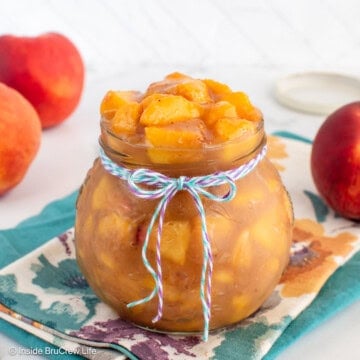 A clear jar filled with a fresh peach filling.