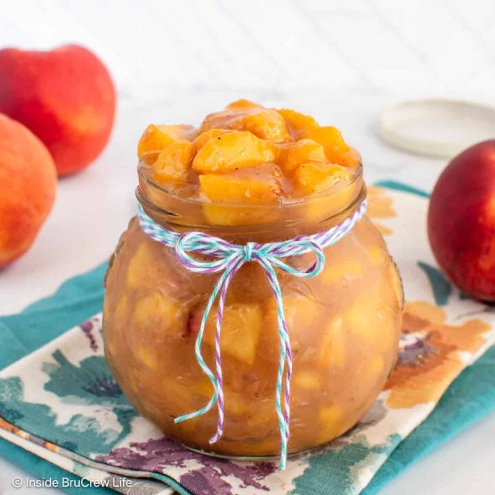 A clear jar filled with a fresh peach filling.