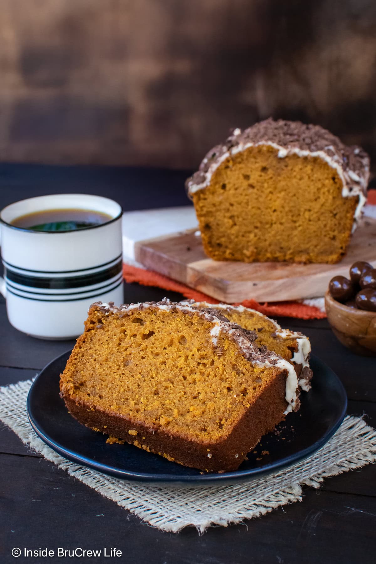 Slices of pumpkin spice bread on a black plate.