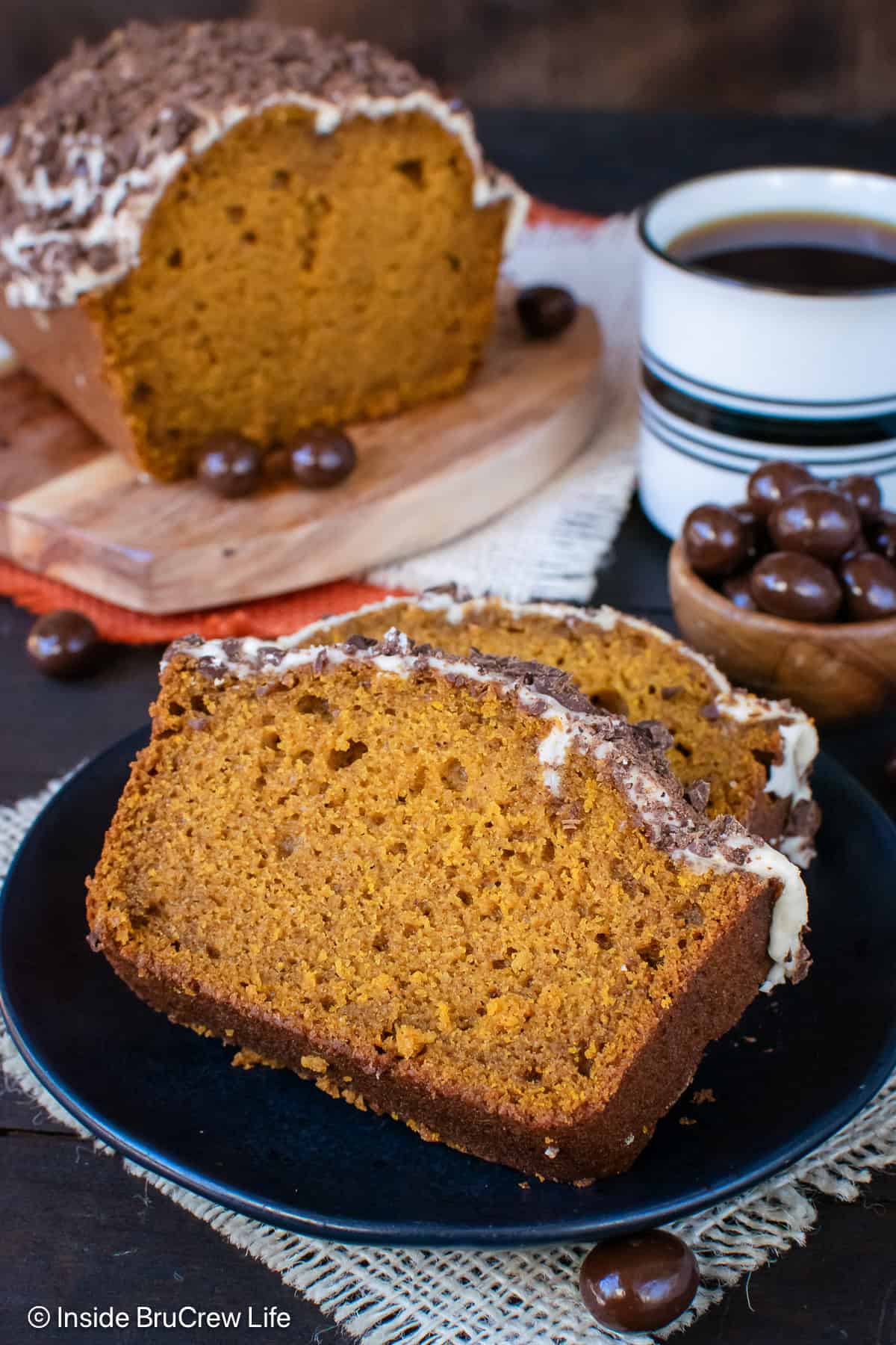 Two slices of pumpkin spice latte bread on a black plate.