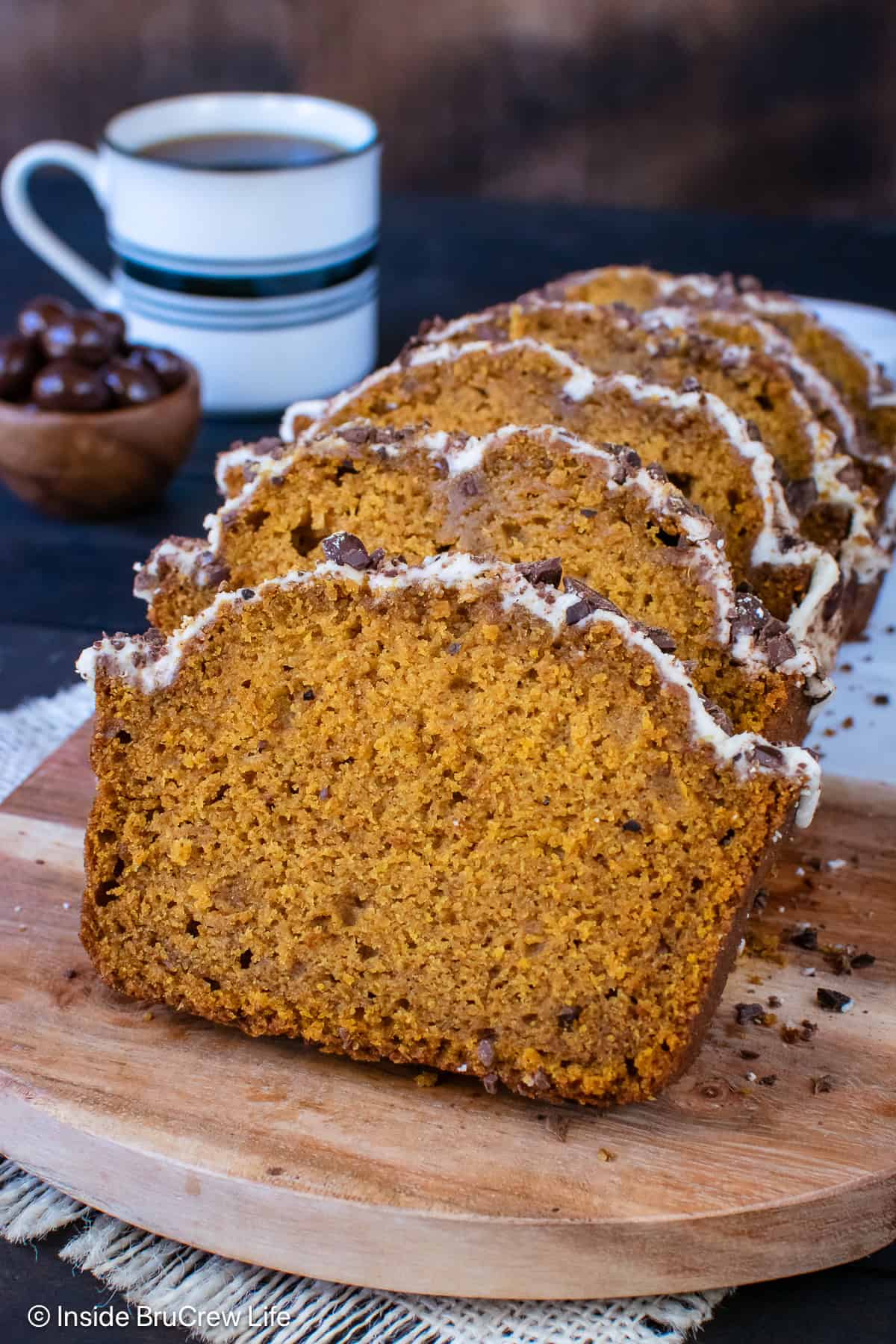 Pumpkin spice latte bread sliced and stacked on a cutting board.