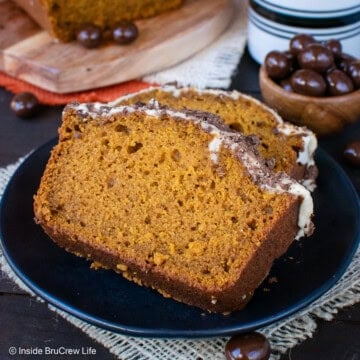 Two slices of pumpkin spice latte bread on a black plate.