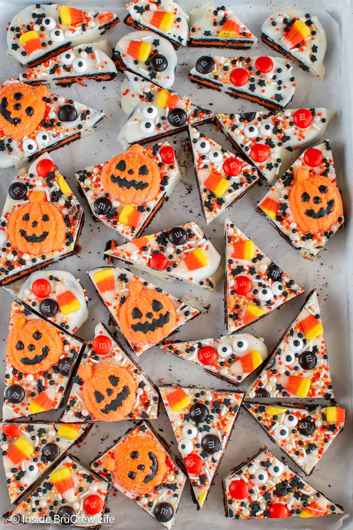 Pieces of Halloween bark on a white tray.