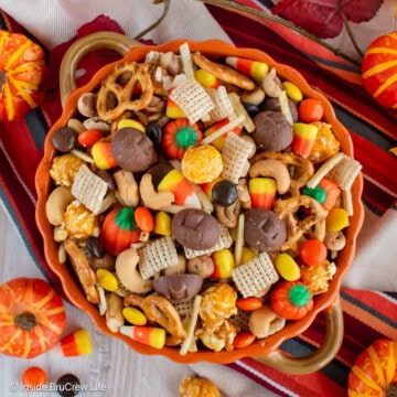 An overhead picture of an orange bowl filled with a fall snack mix.