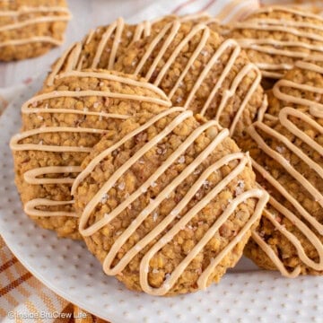 Pumpkin pecan cookies with a coffee glaze on a white plate.