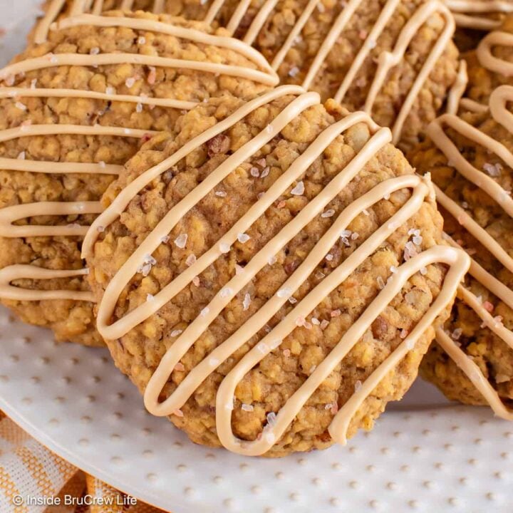Pumpkin pecan cookies with a coffee glaze on a white plate.