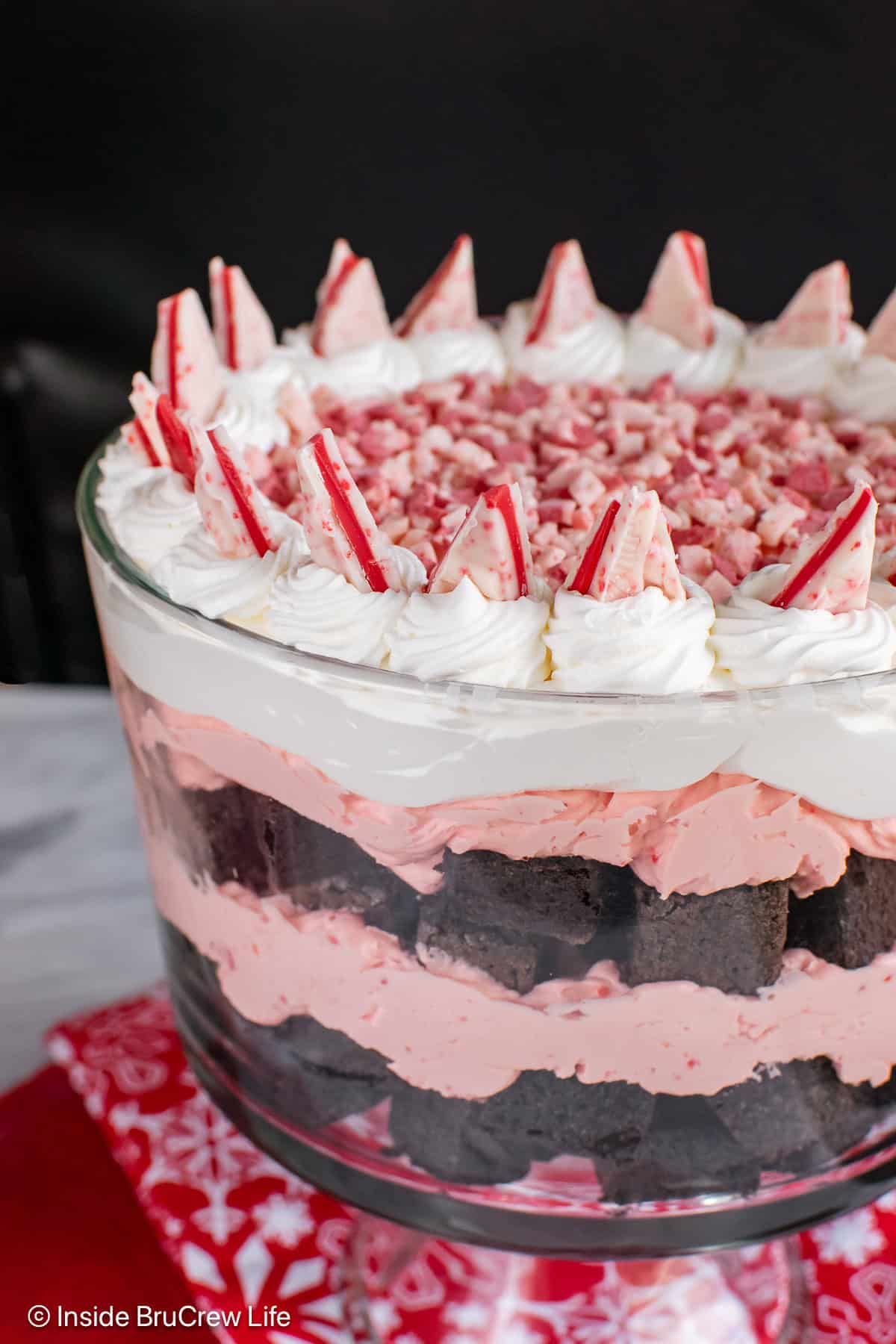 A large glass bowl filled with a peppermint brownie trifle dessert.