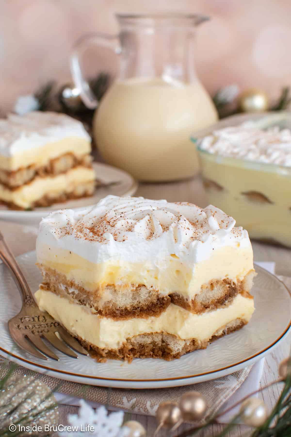 A slice of eggnog holiday tiramisu with a bite taken out of it.