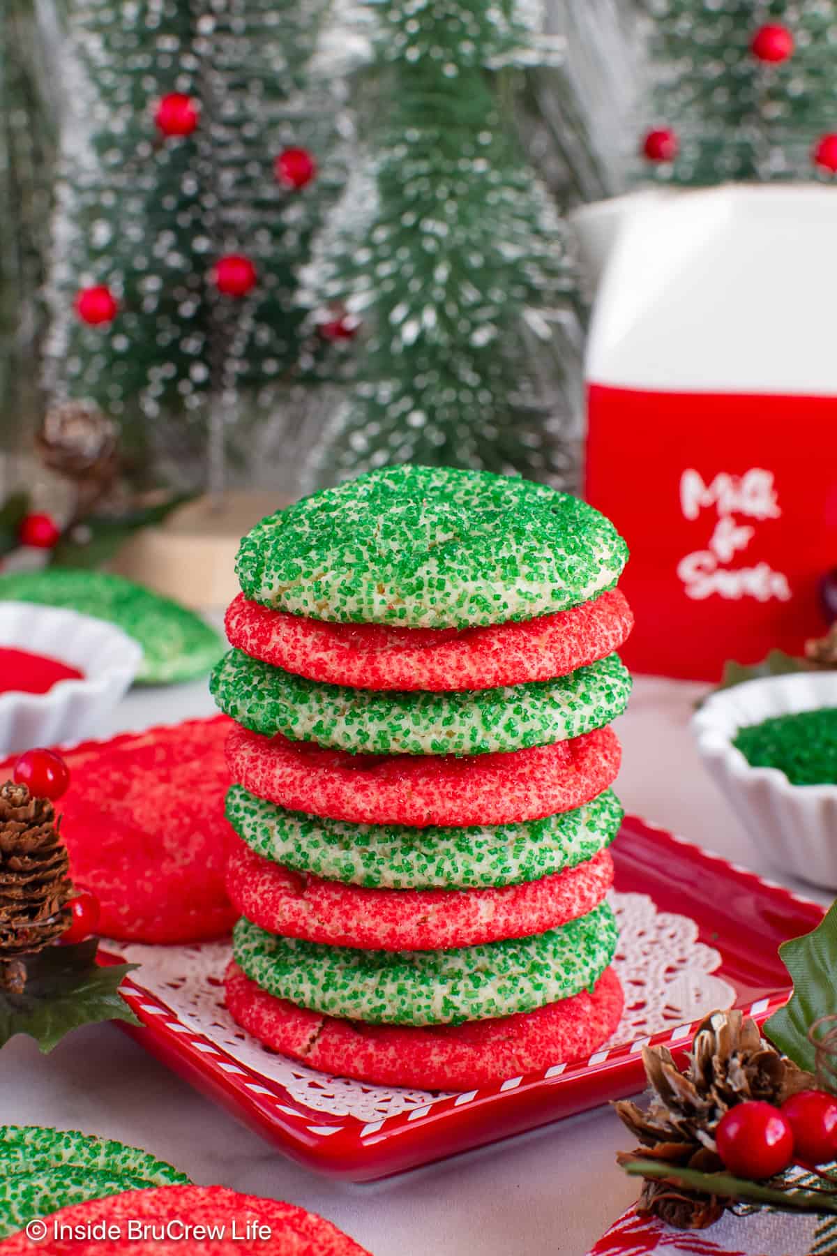 A stack of alternating red and green Christmas cookies on a tray.