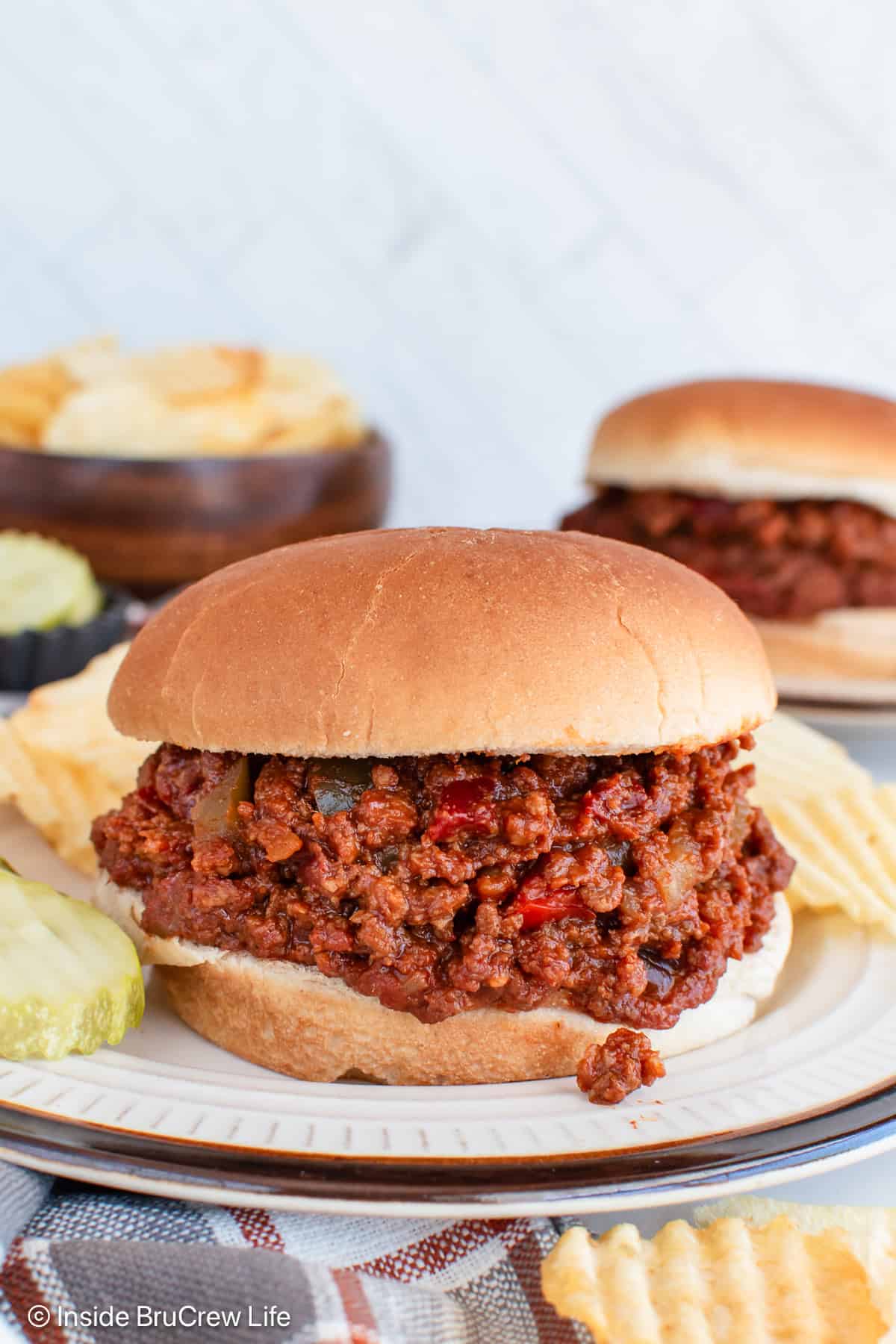 A bun filled with a generous helping of sloppy joes.