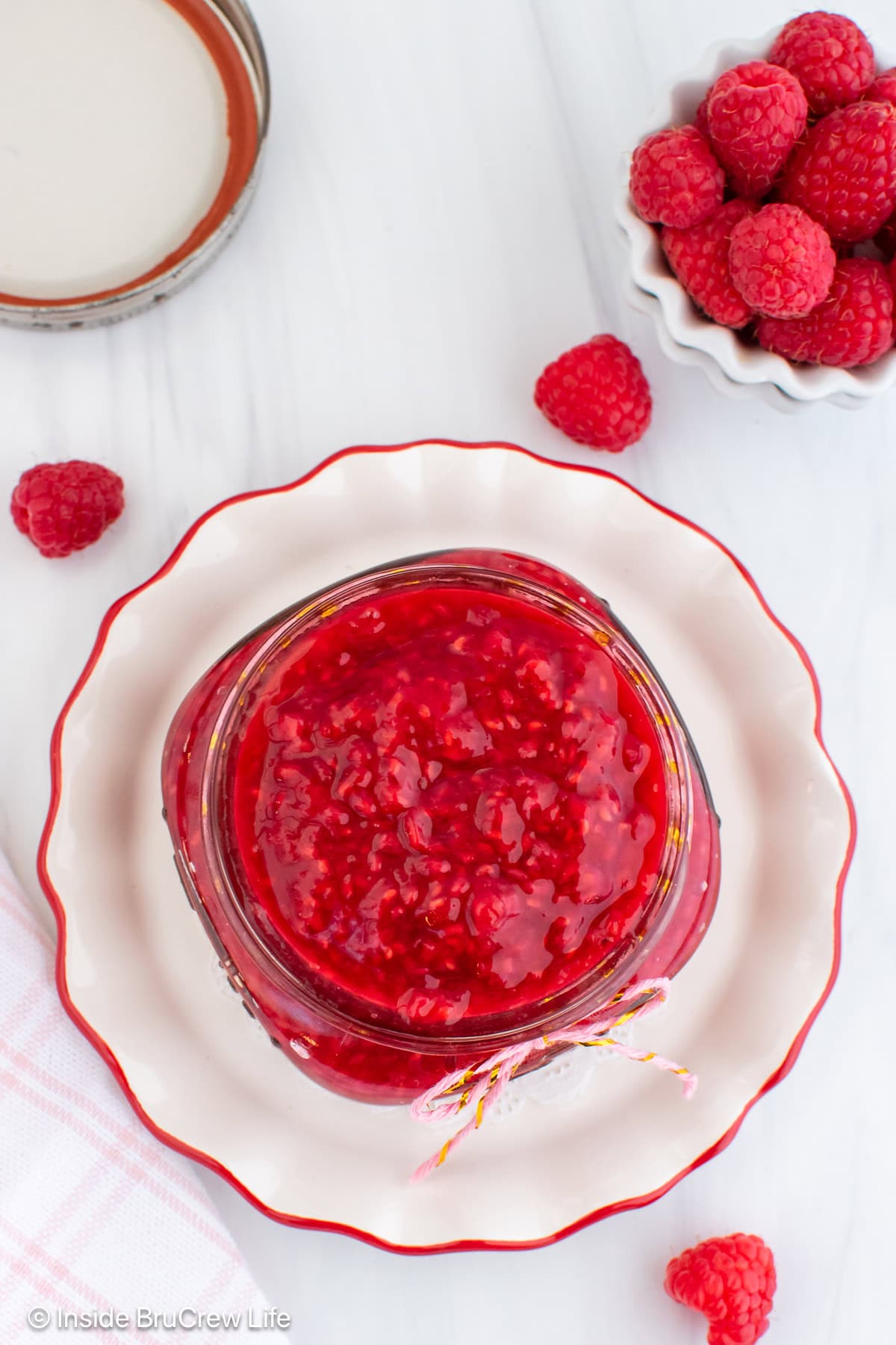 An overhead picture of a jar filled with raspberry pie filling.
