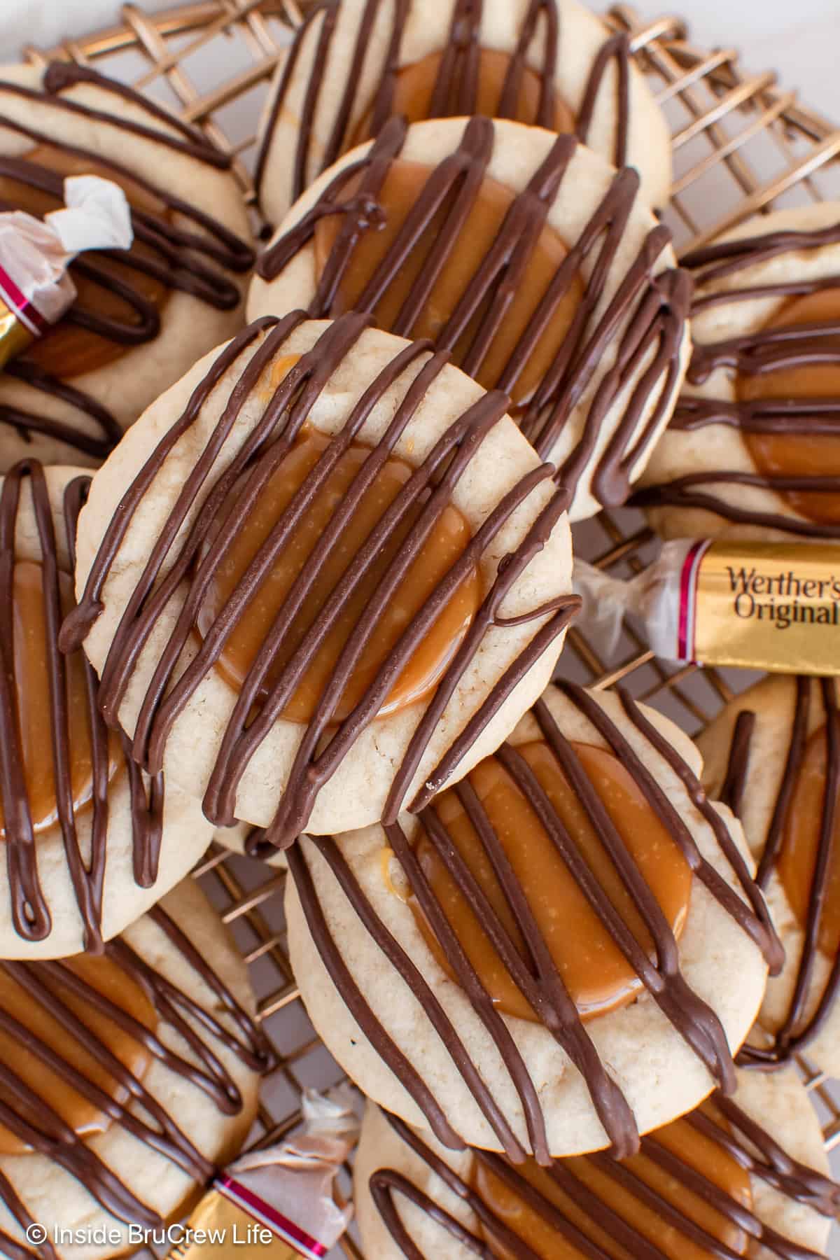 A close up picture of Twix cookies with chocolate drizzles.