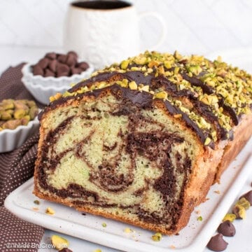 Slices of chocolate pistachio bread on a white tray.