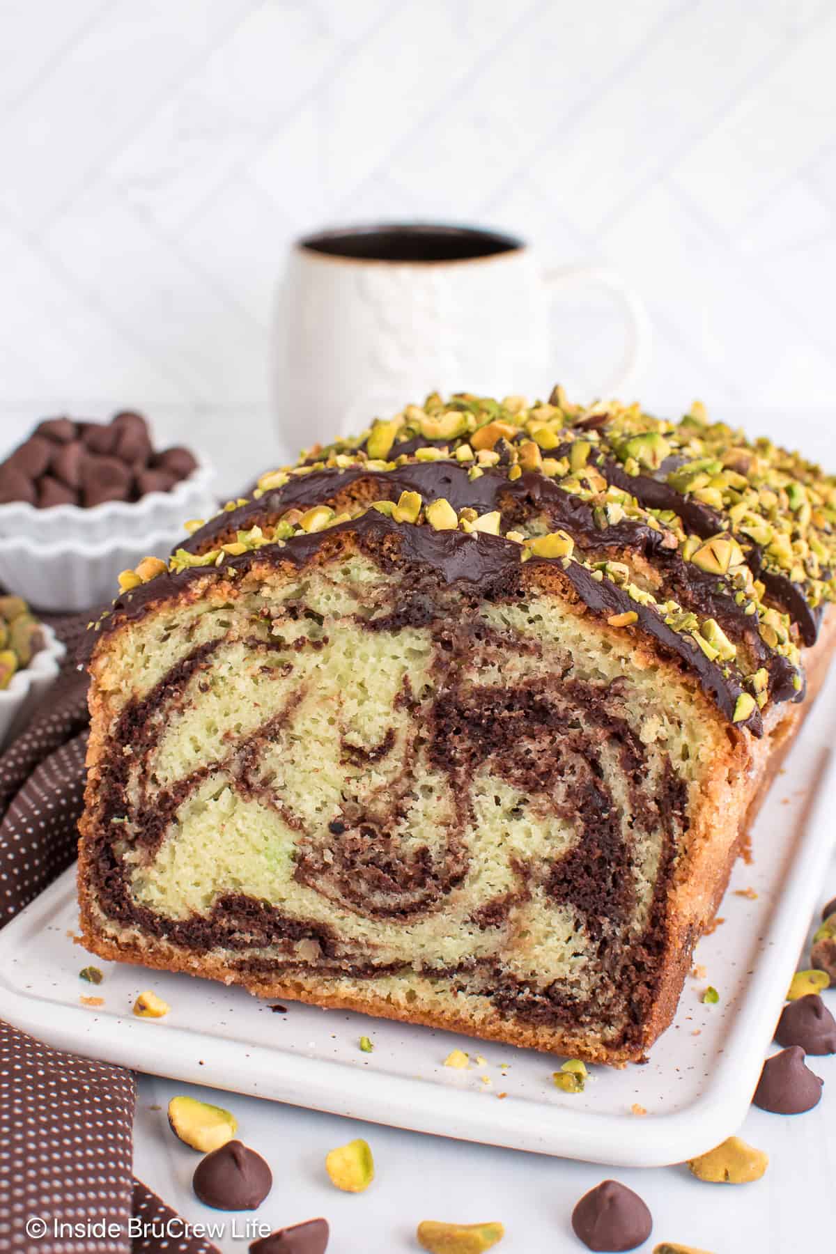 Slices of chocolate pistachio bread on a white tray.